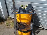 an image of a yellow and black vacuum on a cart