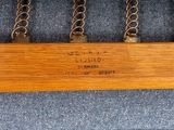 a close up of a wooden rail with chains on it