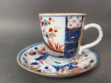 a cup and saucer on a saucer on a table