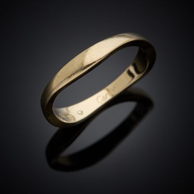 a close up of a gold ring on a black surface