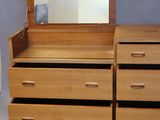 a wooden dresser with a mirror on top of it