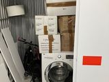 a stack of boxes and a washing machine in a storage room