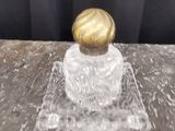 un gros plan sur une petite bouteille en verre avec un bouchon doré