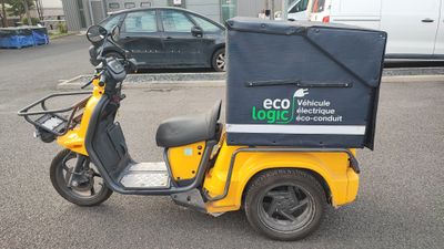 a yellow scooter with a box on the back of it