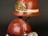 a red fireman ' s helmet with a light on it