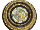 an image of a decorative plate with a picture of a man and woman on it