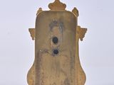 a gold clock that is sitting on a white surface