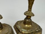 pair of antique brass candlesticks on a white background