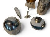 a silver object that is sitting on a white surface