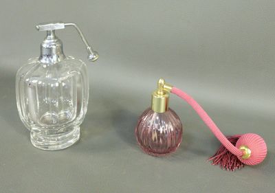 a bottle of perfume next to a bottle of perfume on a table