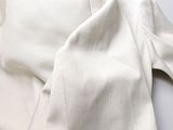 a close up of a white shirt on a white table