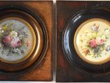 two framed pictures of flowers on the wall
