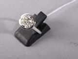 a ring with a diamond on top of a piece of wood