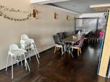 many chairs and tables in this room with wood flooring