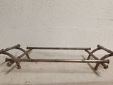 a metal bench that is sitting on a cement floor