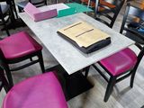 many chairs around a table with a book on it