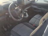 the interior of a small car with a steering wheel and dashboard