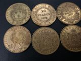 six different coins of different sizes and shapes on a black surface