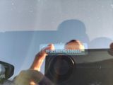a person taking a picture of themselves in a car mirror