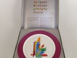 a plate with a picture of a city on it in a box