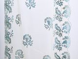 a white curtain with blue and green flowers on it