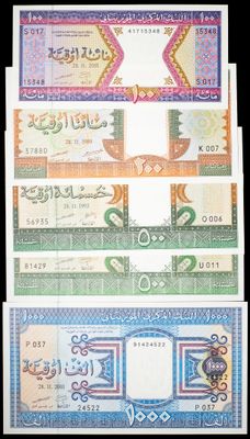 a close up of three different currency notes on a black background