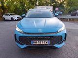 a blue car that is parked in a parking lot