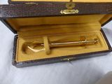 a small wooden box with a metal object inside of it