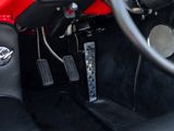 a close up of a car ' s interior with a steering wheel and pedals