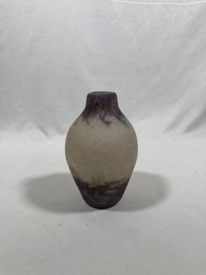 a brown and white vase sitting on a white surface