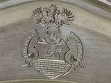 a close up of a silver plate with a crest on it