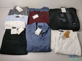 a lot of men ' s shirts and pants laid out on a table