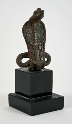 statue of a snake on a pedestal with a white background