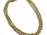 a close up of a gold chain on a white background