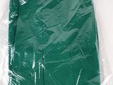 a green napkin wrapped in plastic on a white surface