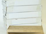 boxes of pizza stacked on top of each other on a white surface