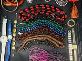 a lot of different bracelets and watches laid out on a table