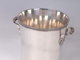 a silver plated ice bucket with handles on a white background