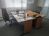 a desk with a laptop and a laptop computer on it