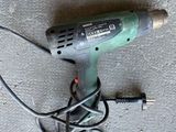 a corded drill and a corded cord on the floor
