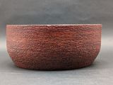 an image of a red bowl sitting on top of a table