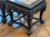 a small table with a marble top on a wooden floor