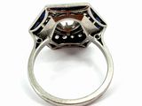 an image of a diamond and sapphire ring on a white surface