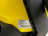 yellow and black vacuum cleaner sitting on top of a yellow machine