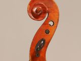 an old violin with a wooden back and a long neck