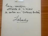 a piece of paper with writing on it sitting on a table