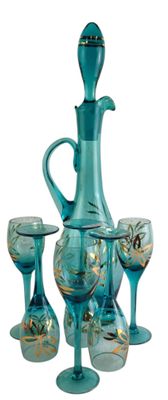 a teal colored glass decanter set with four wine glasses
