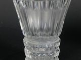 clear glass vase on a black surface with a black background