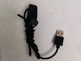 a picture of a black usb charger plugged into a wall