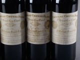 four bottles of wine are lined up on a table